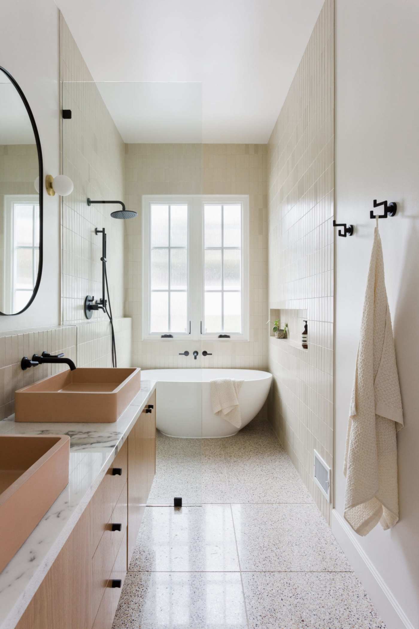 a bathroom with two sinks and a tub.