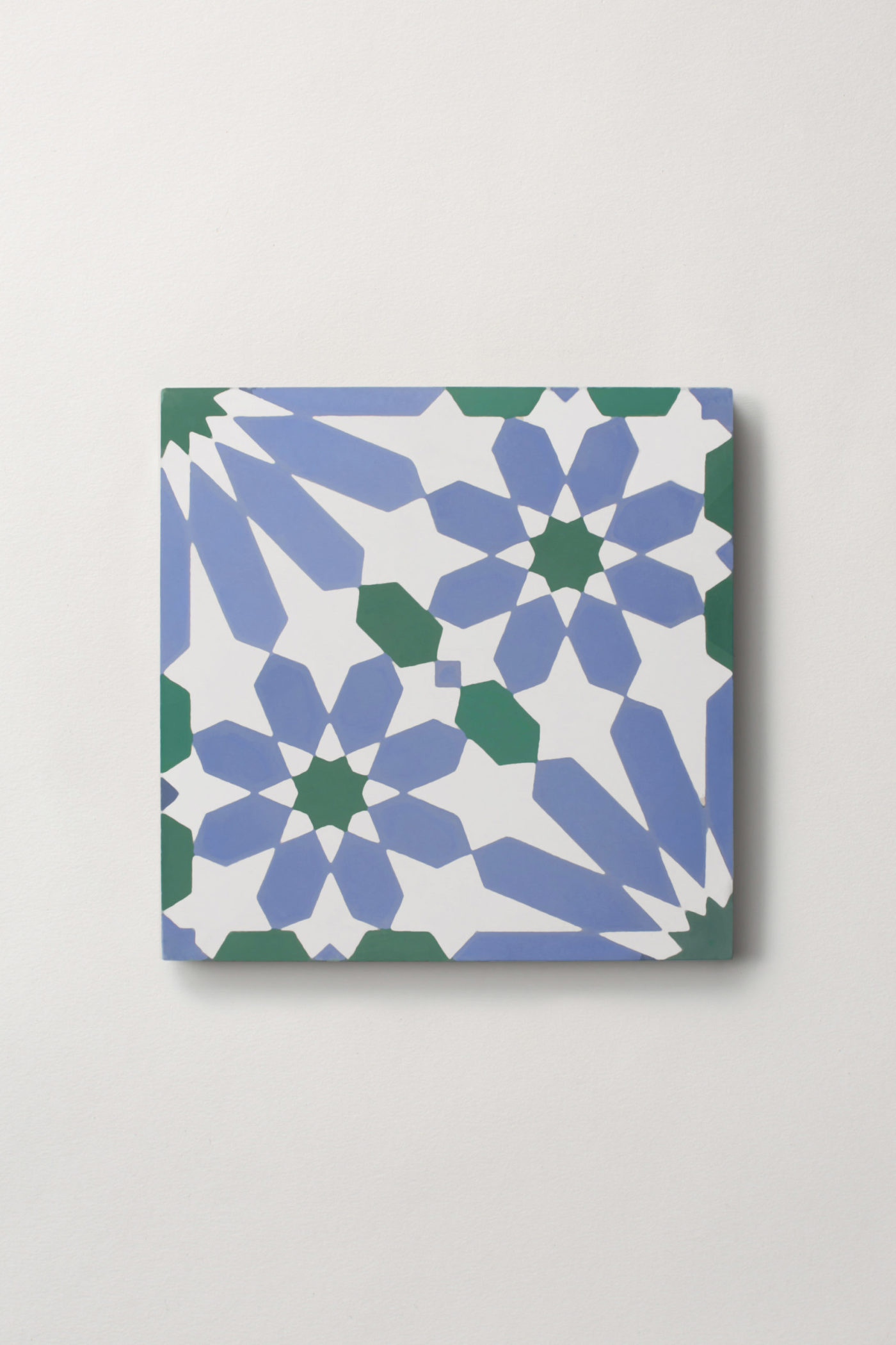 a blue, white, and green tile on a white background.