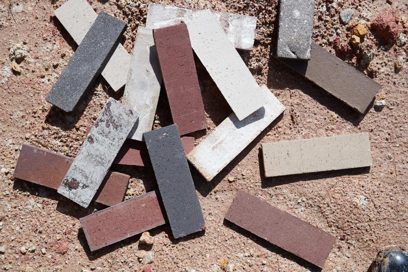 a pile of various colored bricks scattered on the ground.