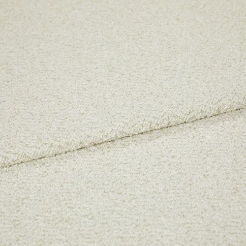 Cream bouclé fabric folded into overlapping layers, showing a horizontal seam; close-up view with soft, even lighting emphasizing the looped texture in a neutral studio setting.