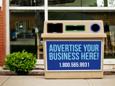triple opening beige outdoor waste and recycling container with a large front body sign for advertising outside a college campus