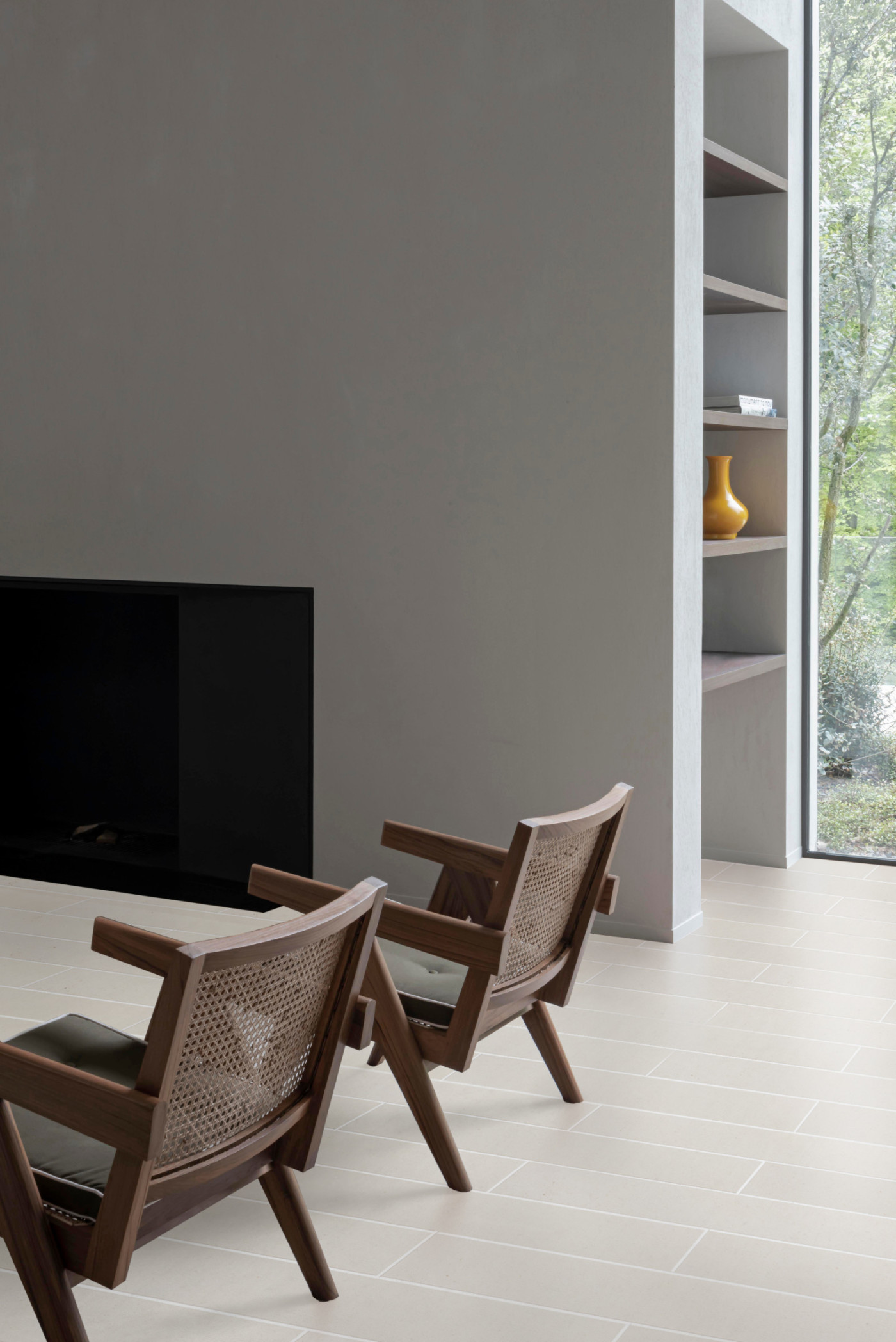 a living room with chairs and a fireplace.