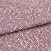 Folded printed cotton fabric with mauve geometric stripe blocks, repeating irregular parallelograms; folded edge runs diagonally, fabric lies flat under soft studio lighting for a close-up textile view.