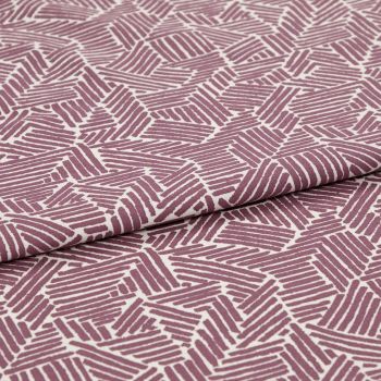 Folded printed cotton fabric with mauve geometric stripe blocks, repeating irregular parallelograms; folded edge runs diagonally, fabric lies flat under soft studio lighting for a close-up textile view.