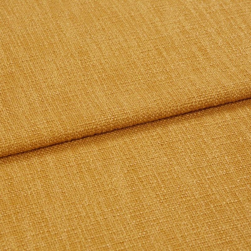 Coarse mustard-yellow woven fabric, folded with a horizontal overlap, showcasing tight textured weave and subtle sheen; close-up under soft, even lighting.