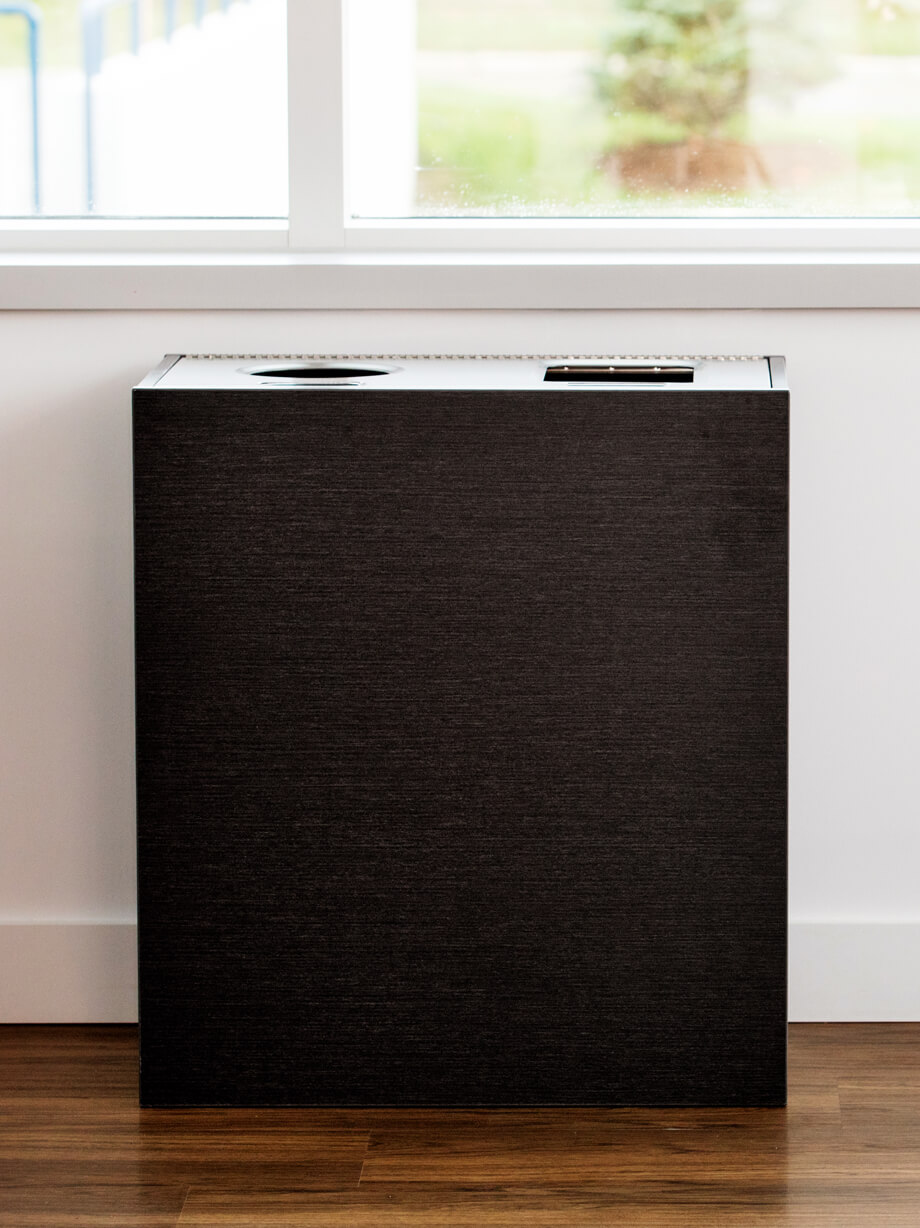 triple high-end waste recycling and organics container with a stainless steel lid and melamine body in a corporate boardroom
