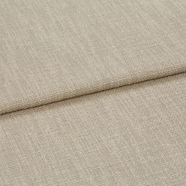 Beige woven fabric folded into overlapping panels, showing coarse textured upholstery weave; a horizontal fold/edge across frame, close-up studio-lit view suggesting a sofa cushion or fabric sample.