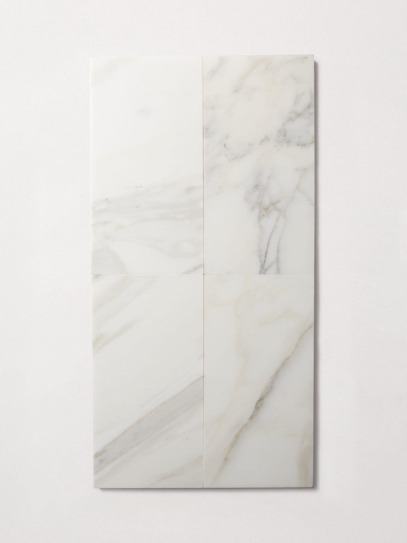 four rectangular white marble tiles on a white surface.