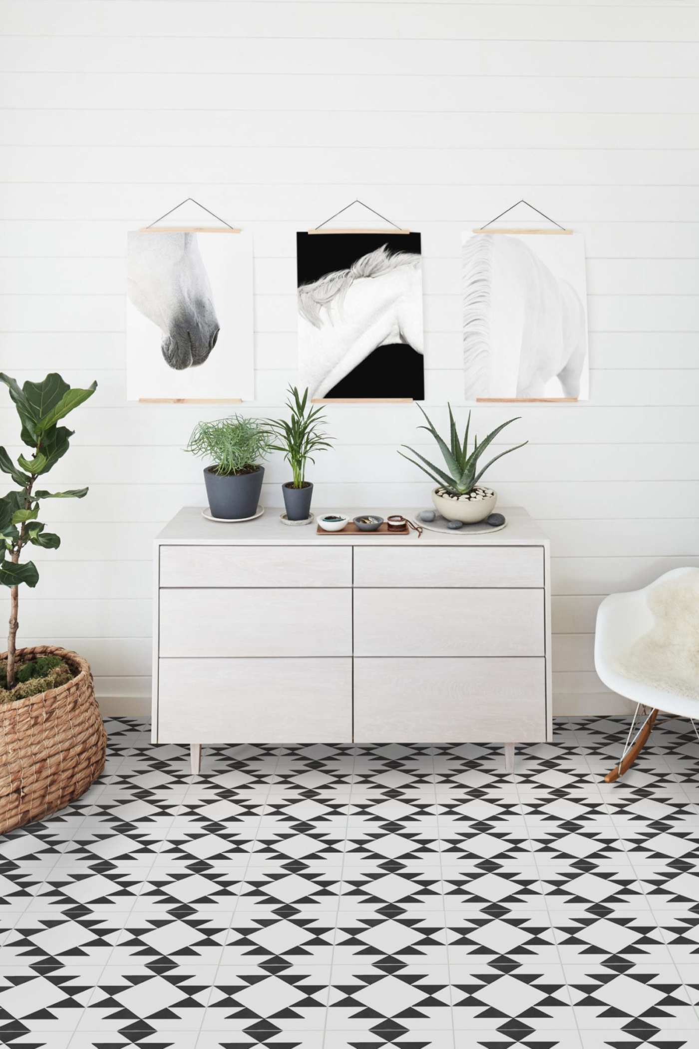 a black and white tiled floor in a room with a dresser.