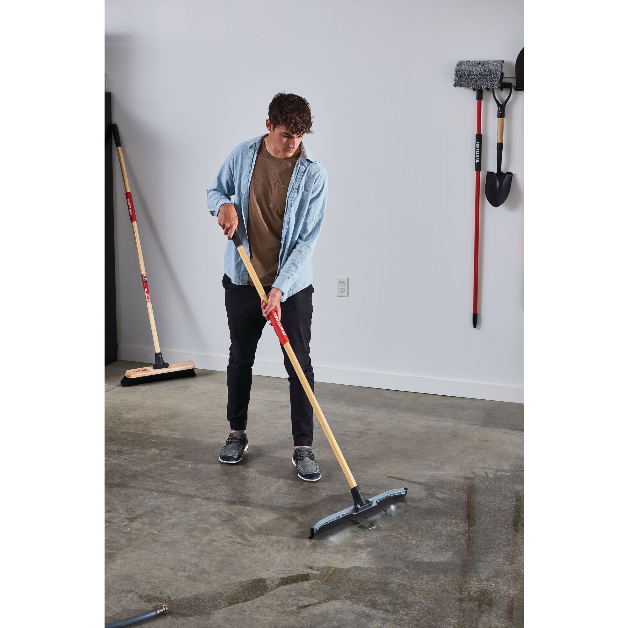 24 inch dual blade floor squeegee being used by a person.