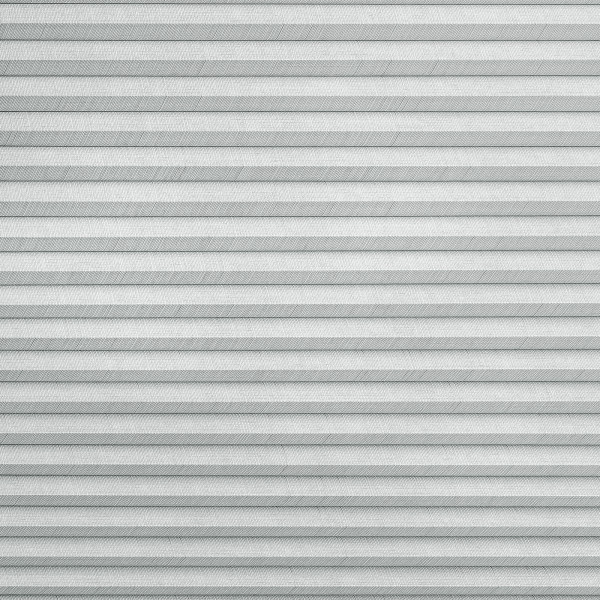 Horizontal pleated (cellular) blind, fully lowered with regular narrow folds and textured fabric, blocking the view and softly diffusing daylight in a neutral, evenly lit interior.