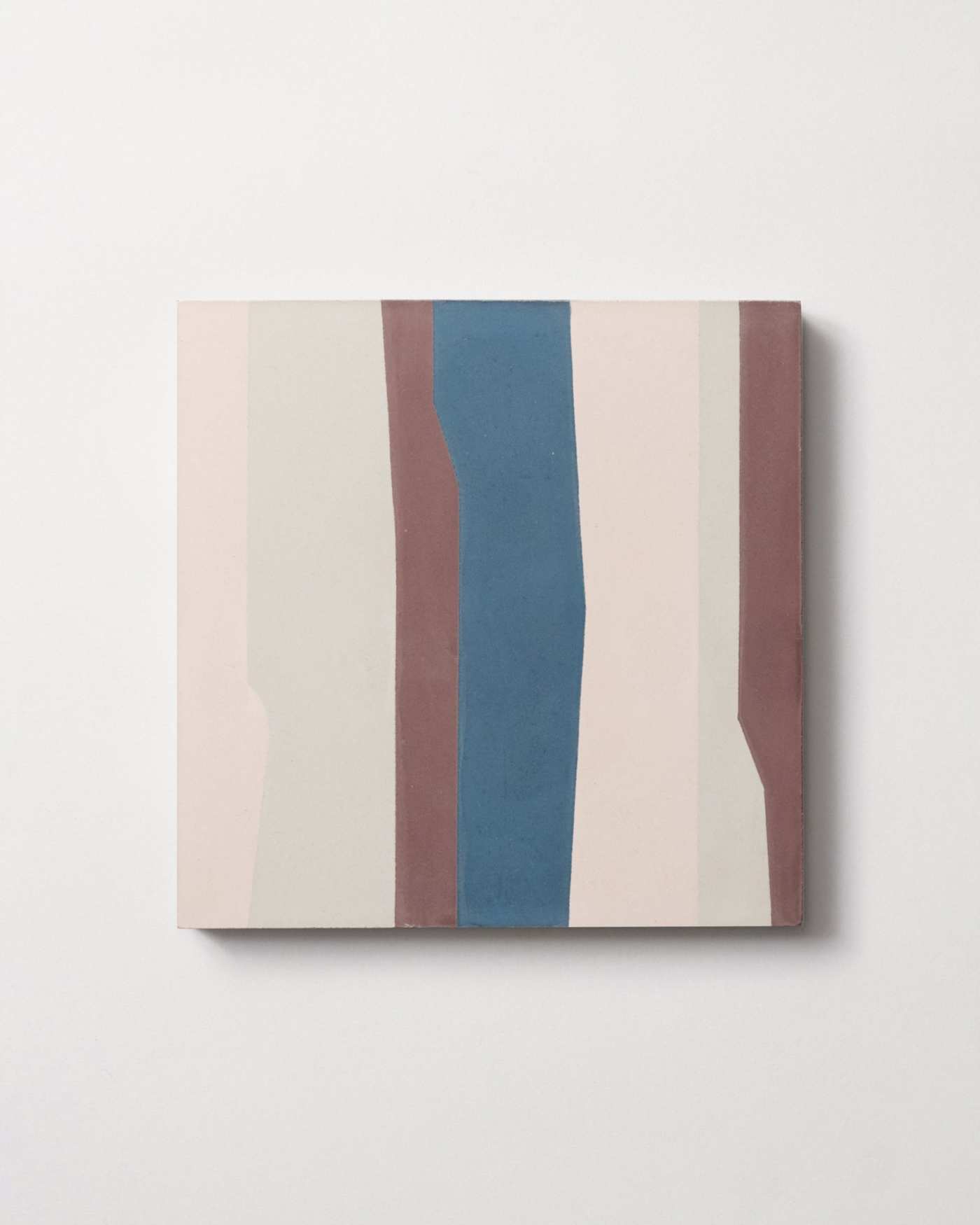 a tile with pink, white, brown and blue stripes on a white background.