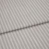 Striped cotton-blend fabric sample, narrow vertical pinstripes in gray on beige, folded once to form a layered edge; close-up studio shot showing woven texture and soft, neutral lighting.