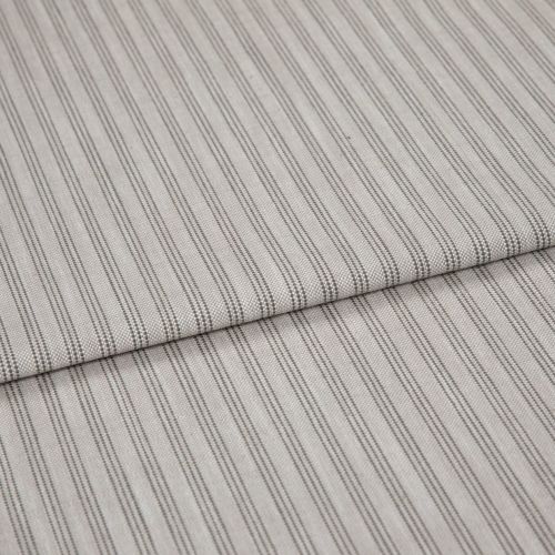 Striped cotton-blend fabric sample, narrow vertical pinstripes in gray on beige, folded once to form a layered edge; close-up studio shot showing woven texture and soft, neutral lighting.