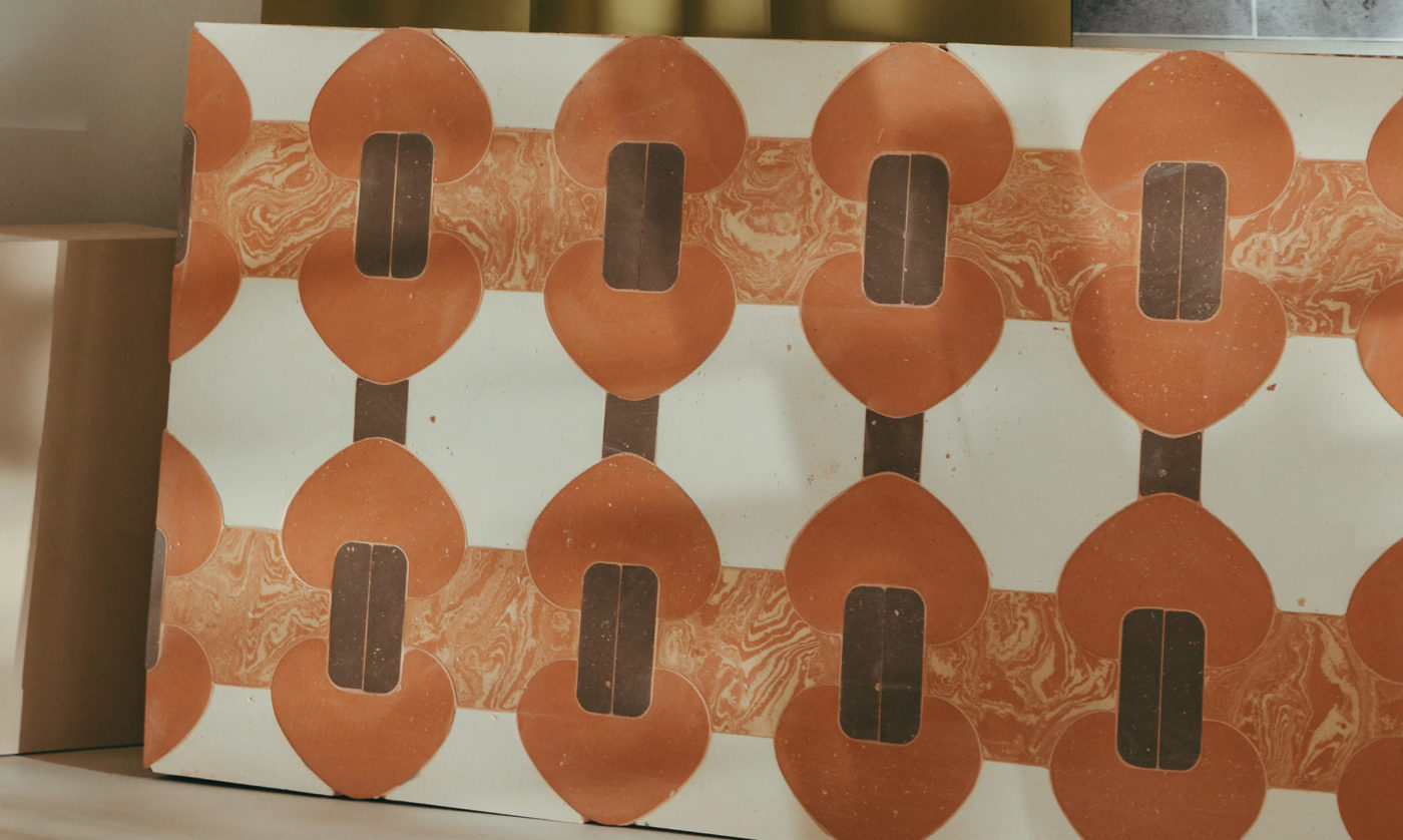 a white, orange, and brown patterned surface sitting on top of a box.