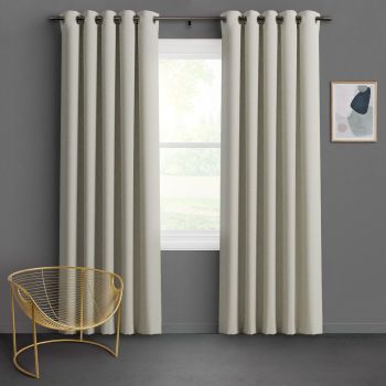 Textured beige grommet-top curtains hang on a metal rod, parted to frame and softly filter daylight through a centered window; gray-walled room with a gold wire chair and abstract art.