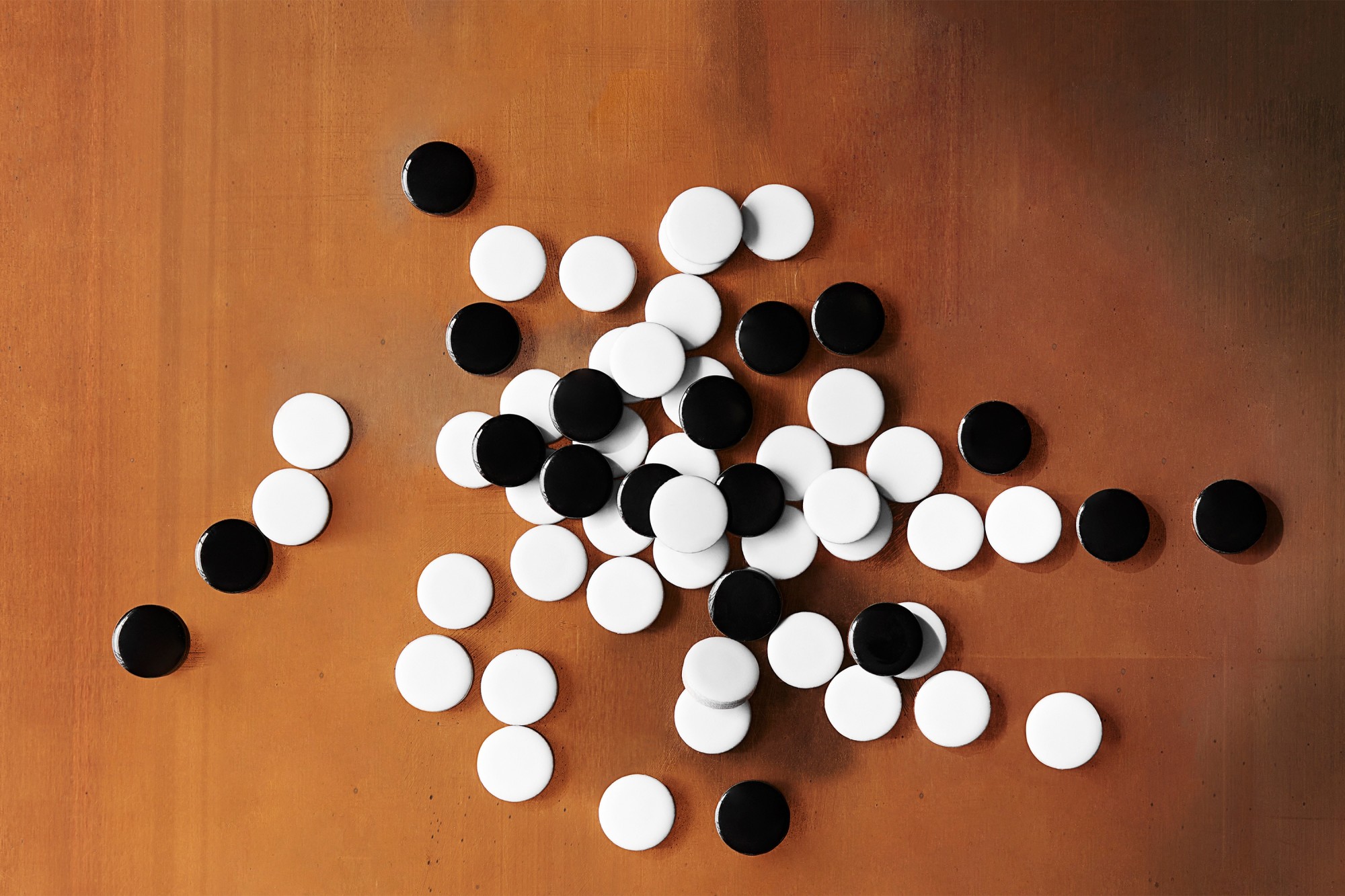 a pile of black and white mosaic tiles on a table.