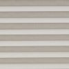 Horizontal pleated cellular shades fully lowered across the window, their alternating light-and-dark bands filtering soft daylight, filling a neutral-toned interior with diffused, even illumination.