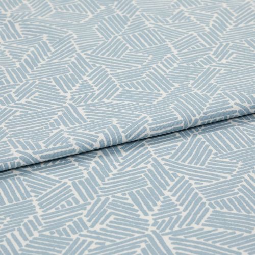 Light blue-and-white patterned fabric with geometric short parallel-stripe blocks; folded with an overlapping edge; close-up on textile surface under soft, even studio lighting.