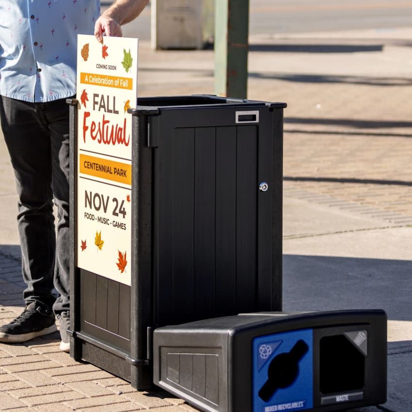 black recycled plastic outdoor durable dual stream waste and recycling bin with large body signs for advertising events or selling ad space.