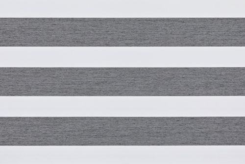 Layered horizontal roller blinds covering a window, alternating textured grey opaque and white sheer bands; positioned to filter light, in a neutral, softly lit interior with no visible view.