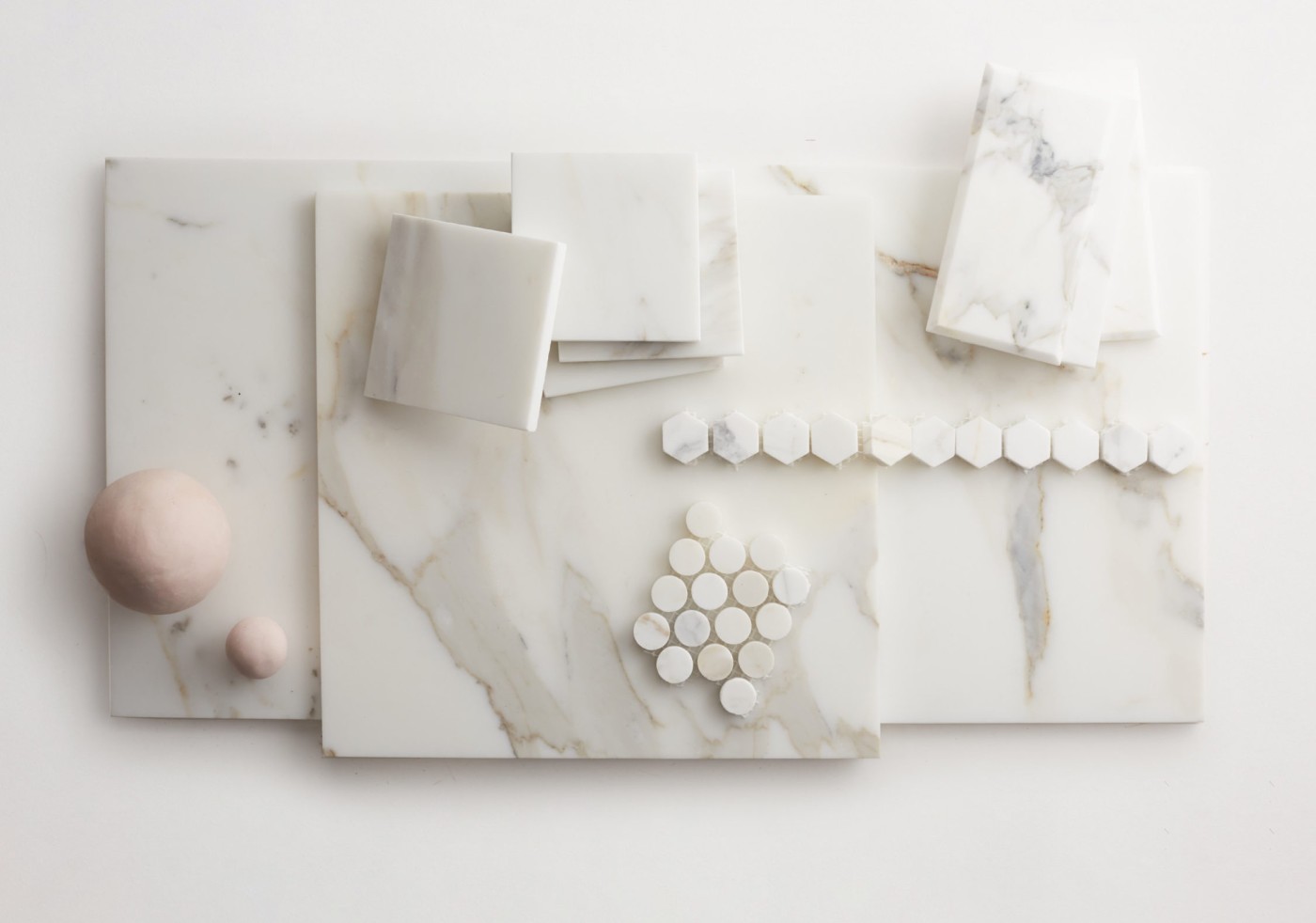 various shapes of white marble tile on a white surface.