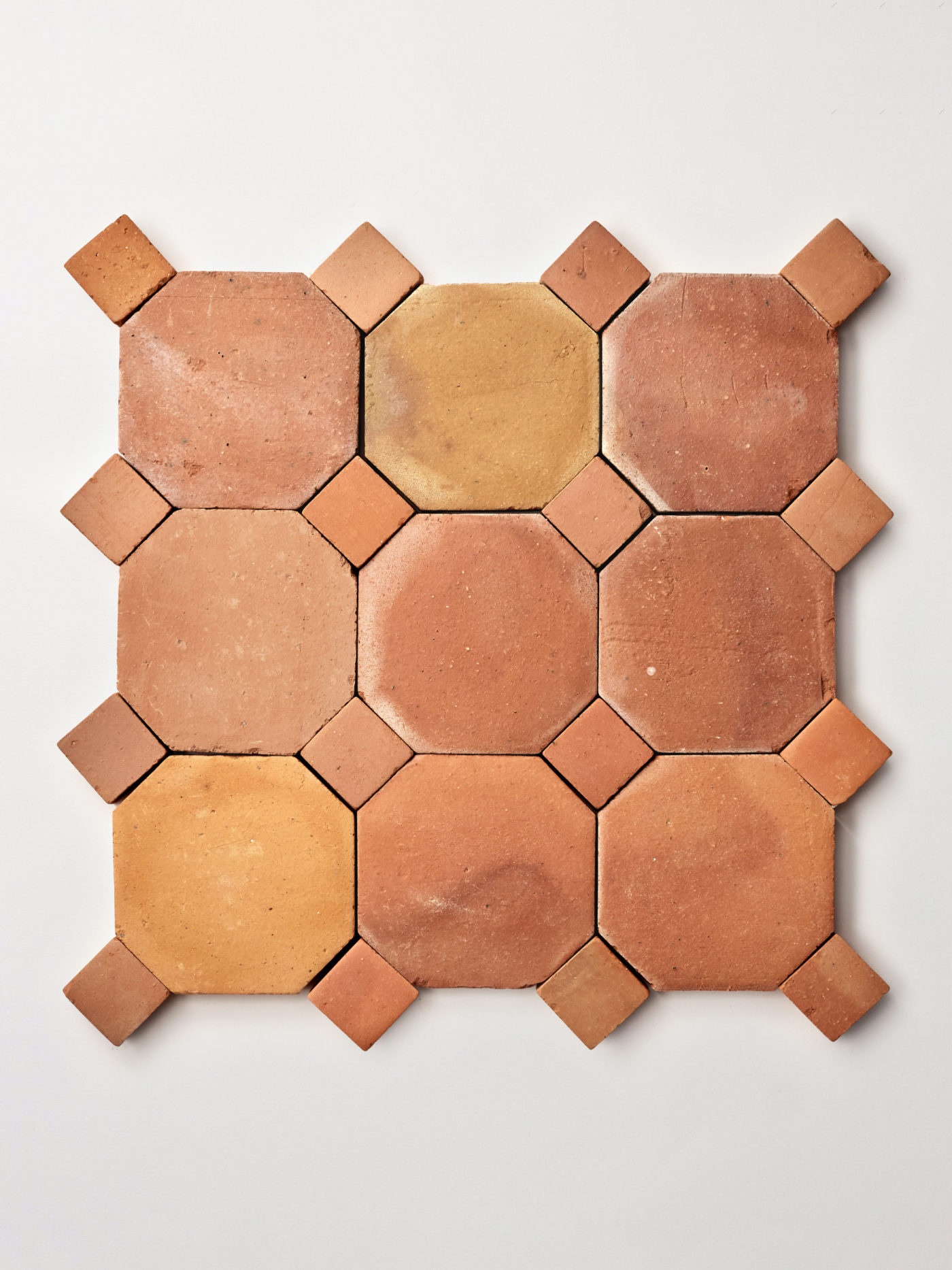 terracotta tiles arranged in a pattern on a white surface.