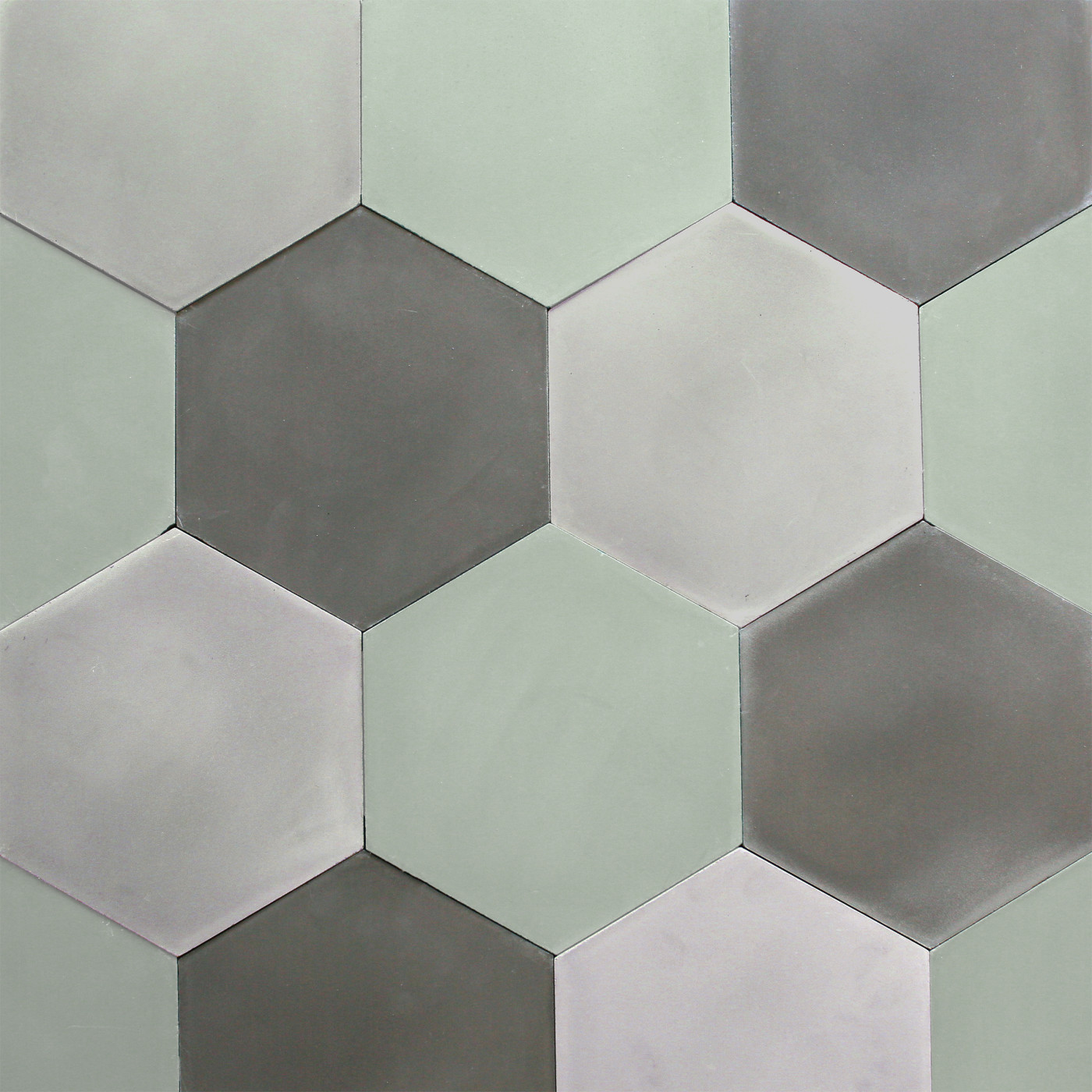 a surface with green and grey hexagon tiles.