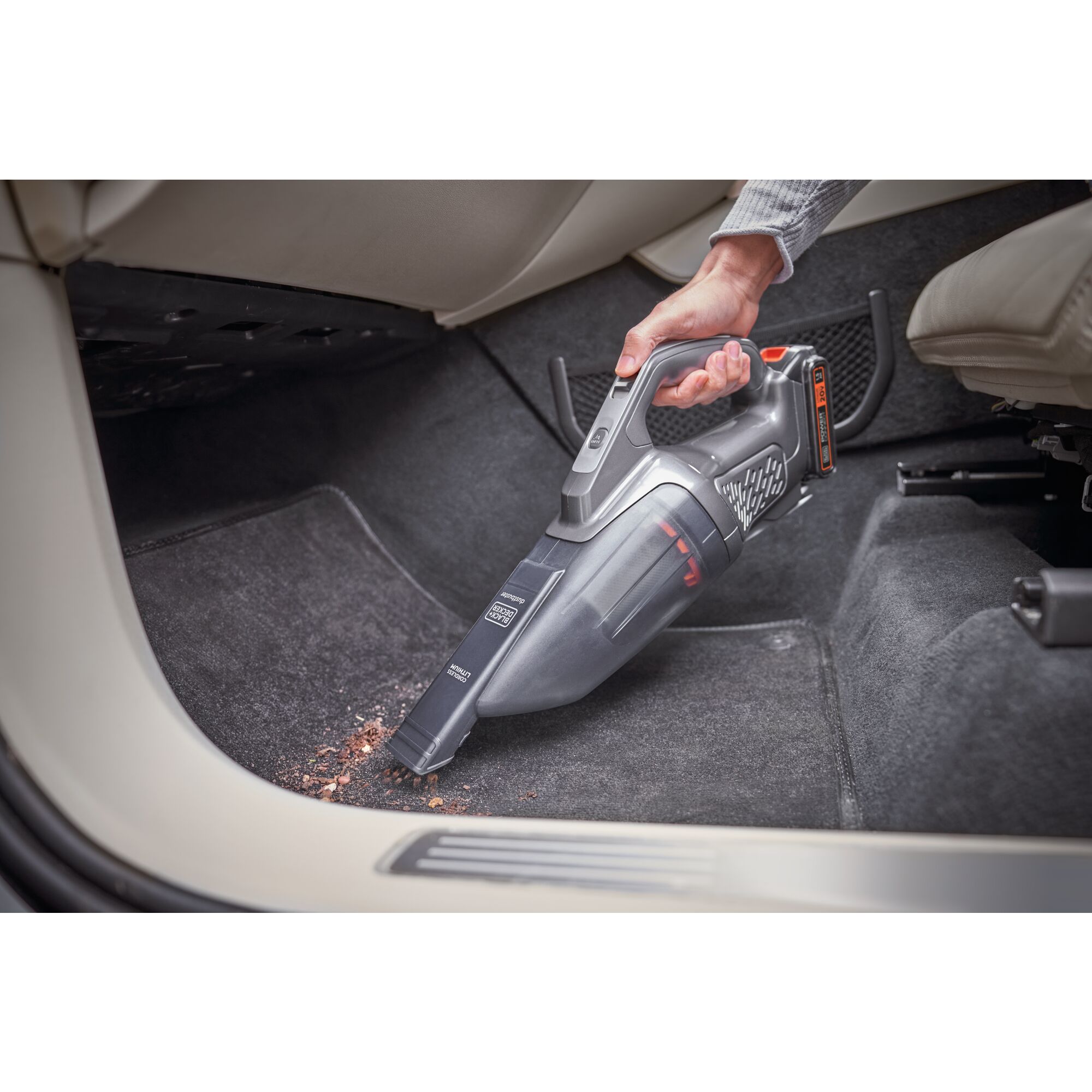 Black and decker Dustbuster 20V MAX* POWERCONNECT Cordless Handheld Vacuum being used to clean up a mess from a car floor