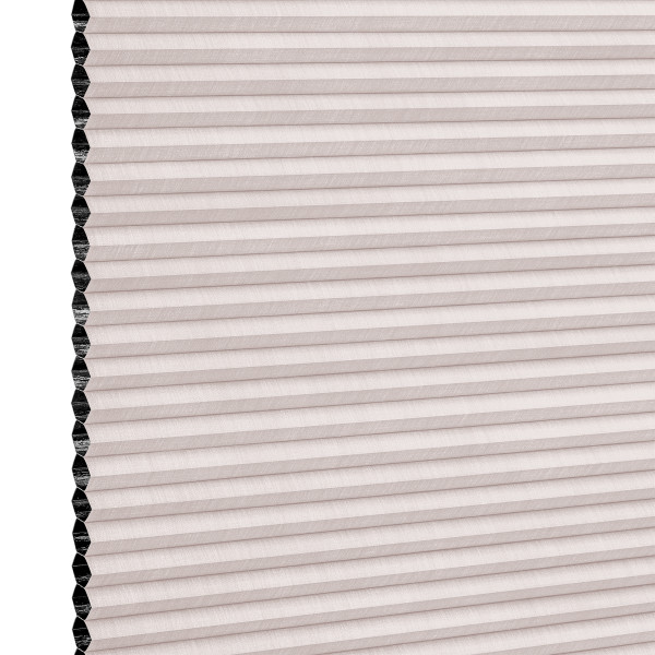 Cellular pleated window shade (honeycomb design) fully lowered, pale blush fabric with visible black cell openings at left edge, blocking light; close-up view against a neutral background.