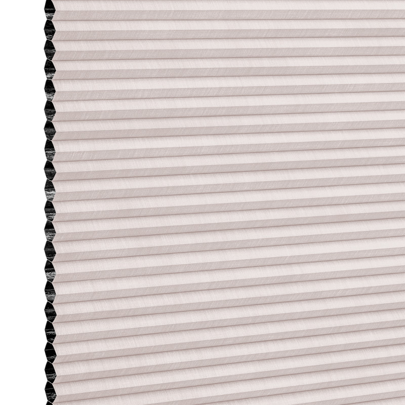Cellular pleated window shade (honeycomb design) fully lowered, pale blush fabric with visible black cell openings at left edge, blocking light; close-up view against a neutral background.
