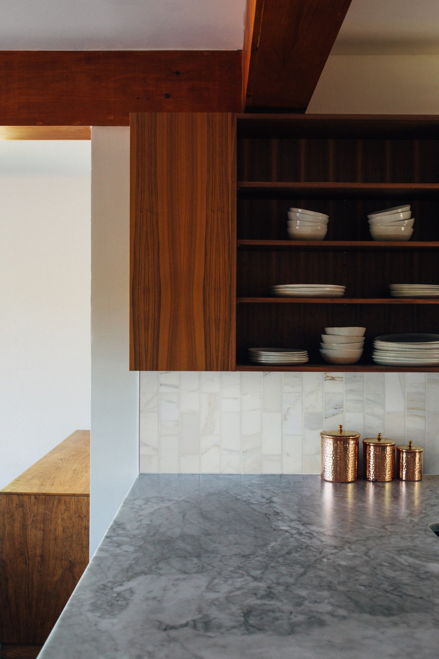 a kitchen with wooden cabinets and a marble counter top.