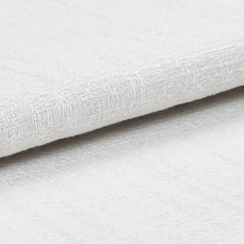 White textured fabric roll with coarse woven pattern; layered and slightly folded, resting overlapped on a matching textured surface in bright, diffuse studio lighting, close-up detail.