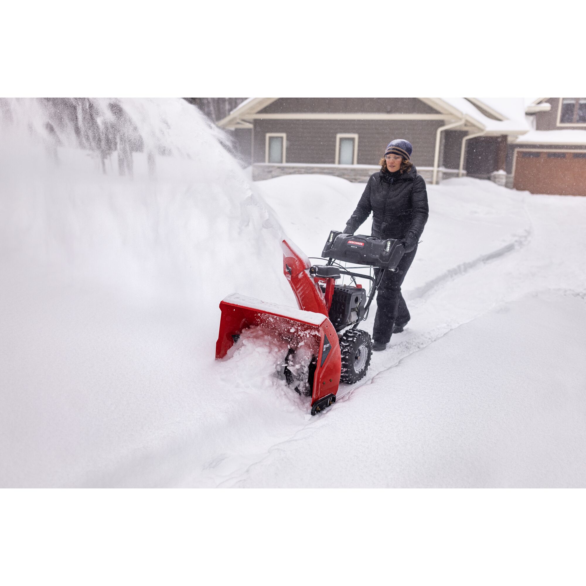 CRAFTSMAN Select 28 Snowblower clearing snow off driveway near house