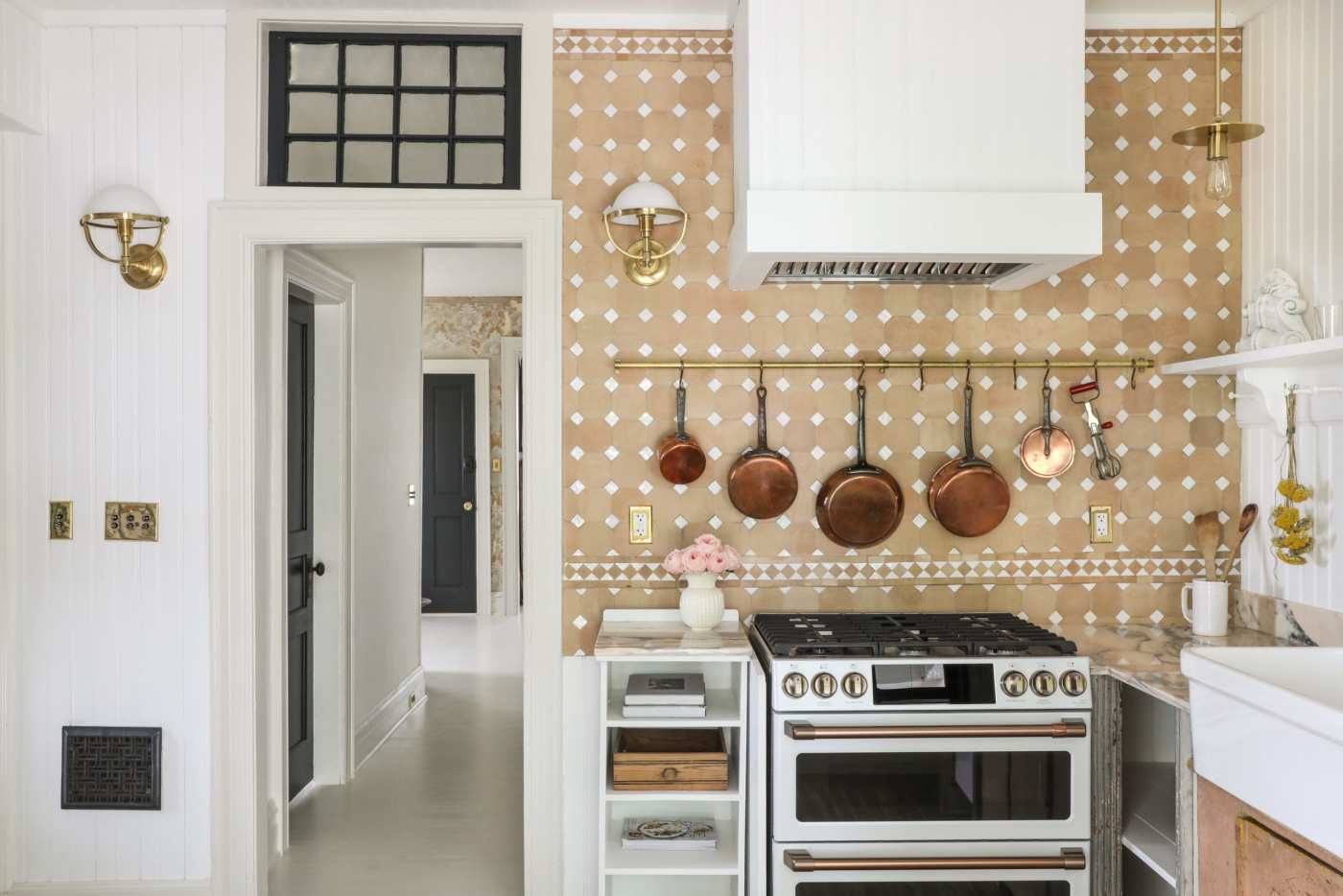 a kitchen with a yellow and white tile backsplash.