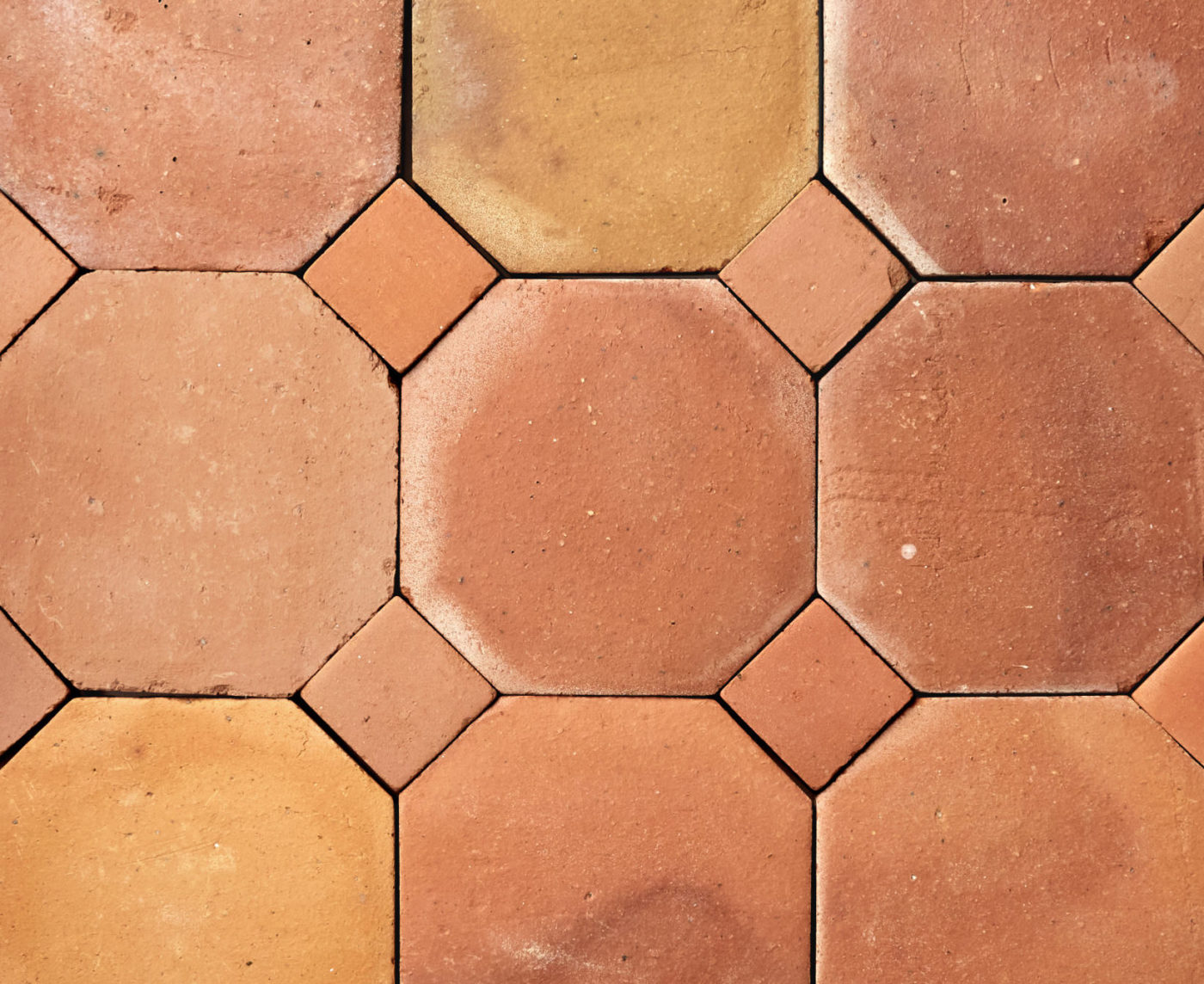 a close up image of a terracotta tiles in a pattern.