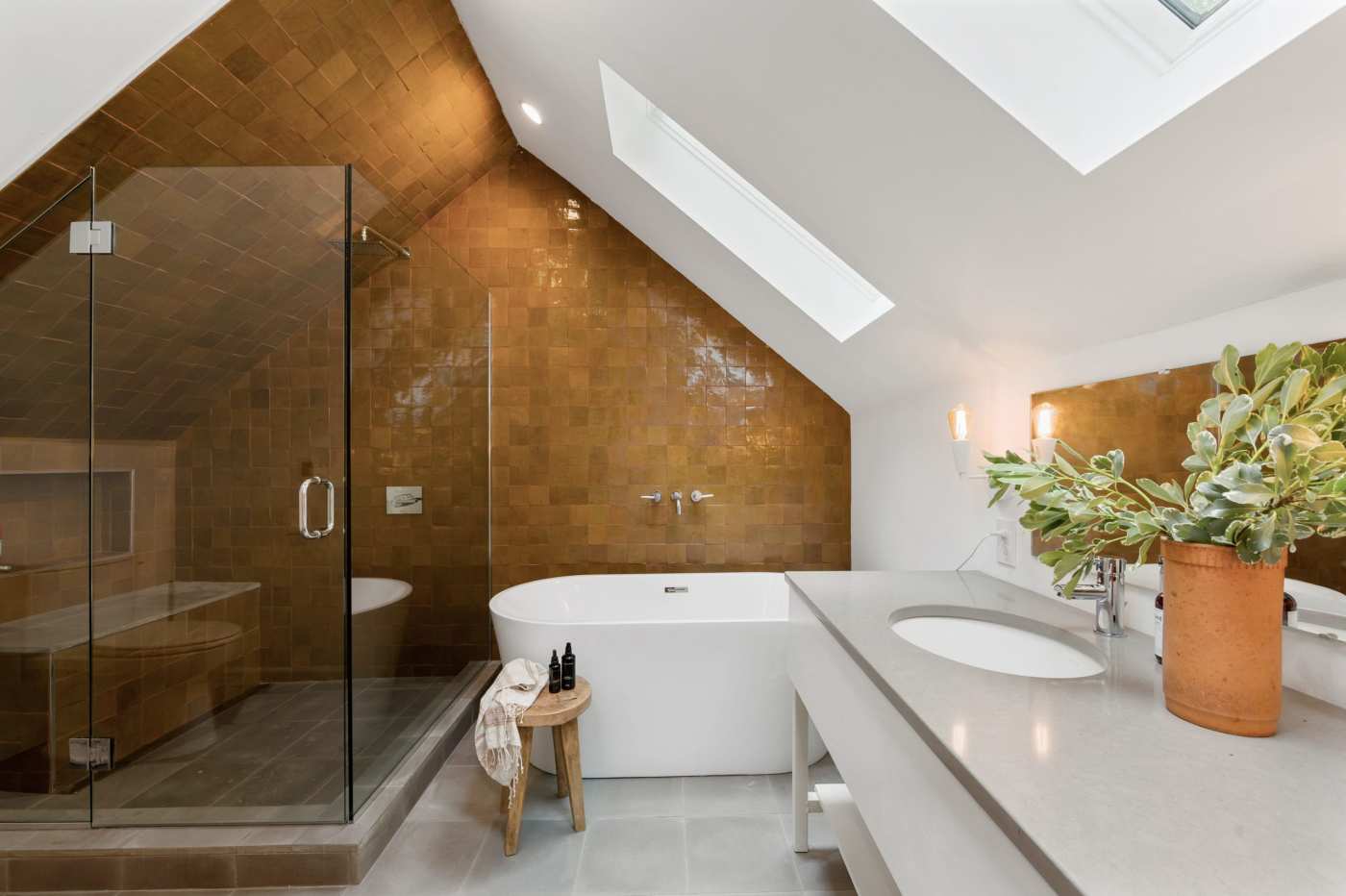 an attic bathroom with a tub and shower.