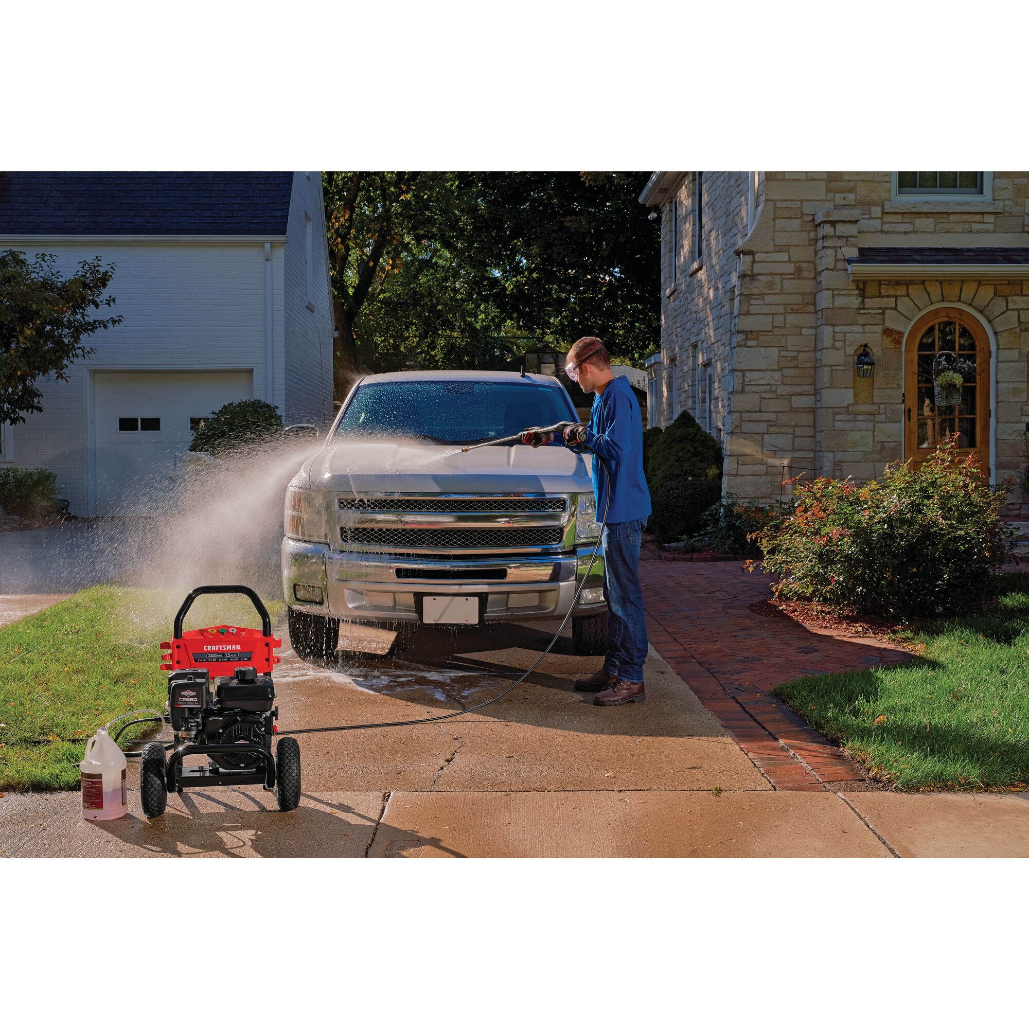 3400 MAX Pounds per Square Inch or 2 and five tenths MAX Gallons Per Minute Pressure Washer being used by person to wash car bonnet outdoors.
