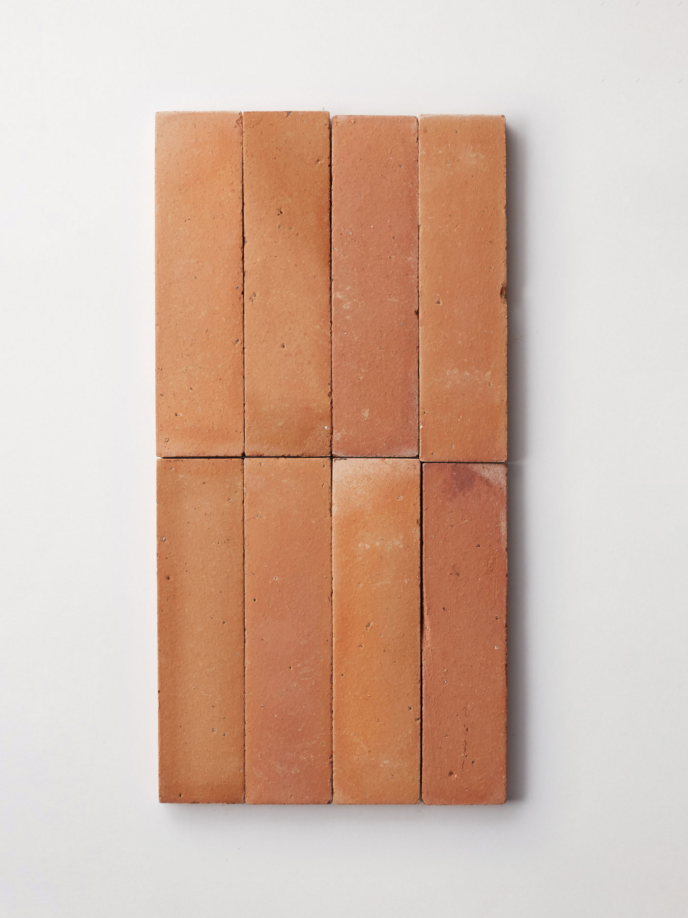 a group of rectangular terracotta tiles on a white background.