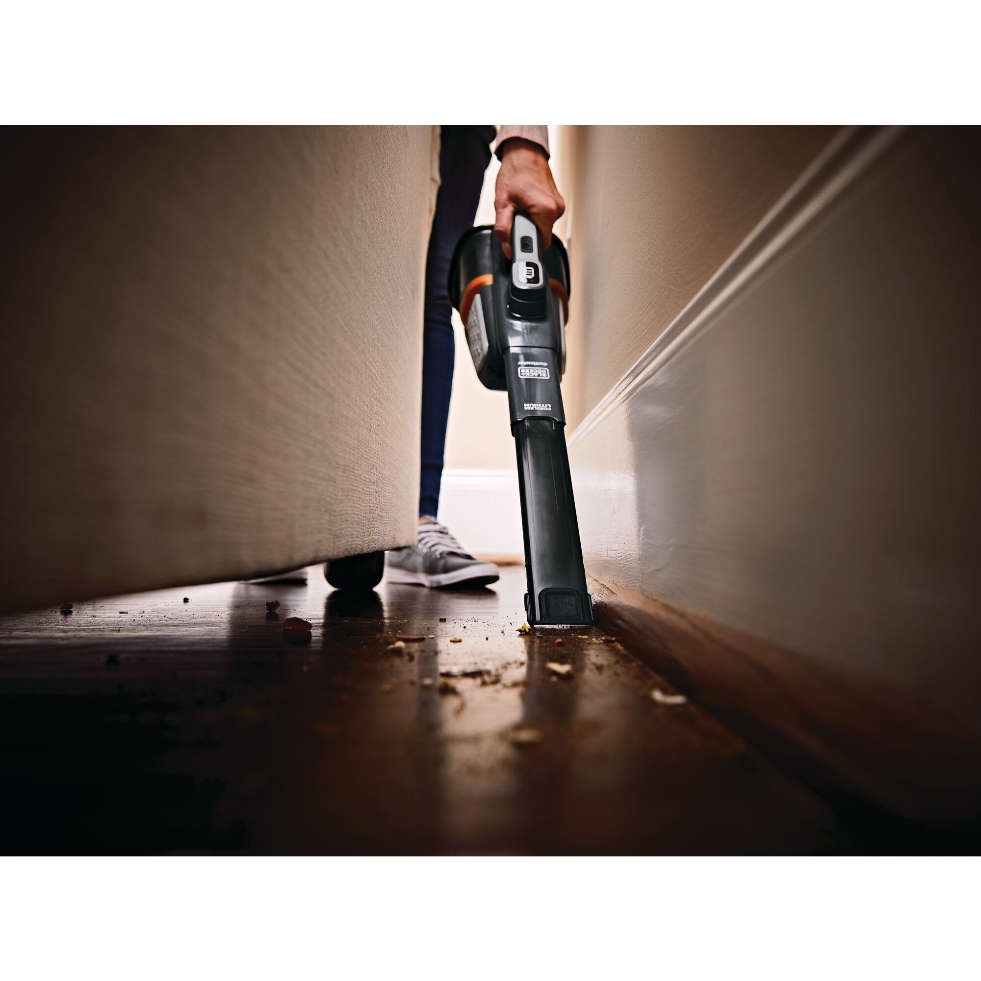 16 Volt dust buster Advanced Clean plus Hand Vacuum being used in a tight space.