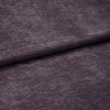 Plush purple velvet fabric with soft fine nap, horizontally folded near center and overlapping itself; close-up studio view emphasizing texture and subtle sheen under diffuse lighting.