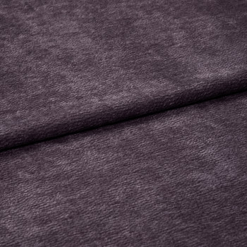 Plush purple velvet fabric with soft fine nap, horizontally folded near center and overlapping itself; close-up studio view emphasizing texture and subtle sheen under diffuse lighting.