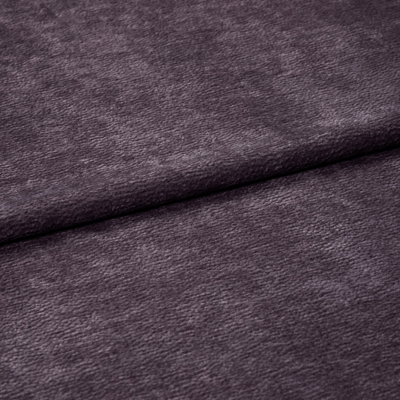 Plush purple velvet fabric with soft fine nap, horizontally folded near center and overlapping itself; close-up studio view emphasizing texture and subtle sheen under diffuse lighting.