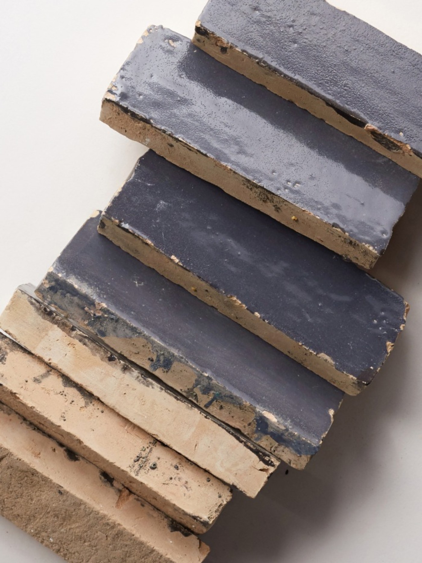 a stack of blue tiles on a white surface.