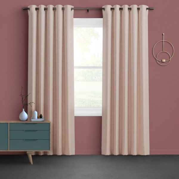 Beige grommet-top curtains hung from a metal rod, drawn slightly apart to filter bright daylight through a central window; muted rose walls, teal mid-century sideboard, circular wall sconce.