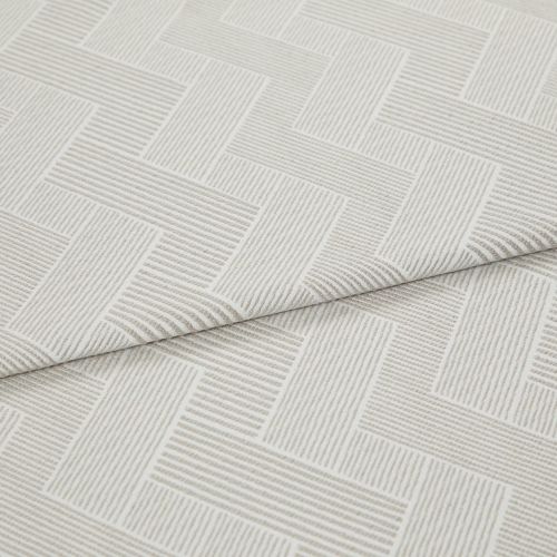 Cream textured fabric with raised linear herringbone rectangles, folded and overlapping across the frame, showing ribbed weave detail in a close-up product shot with soft, diffuse lighting.
