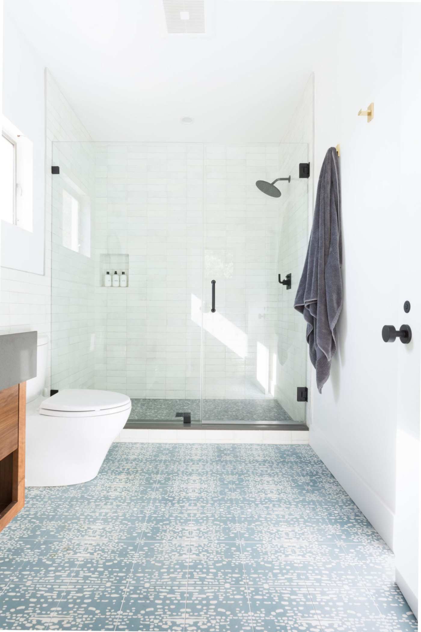 a bathroom with a blue and white tiled floor.