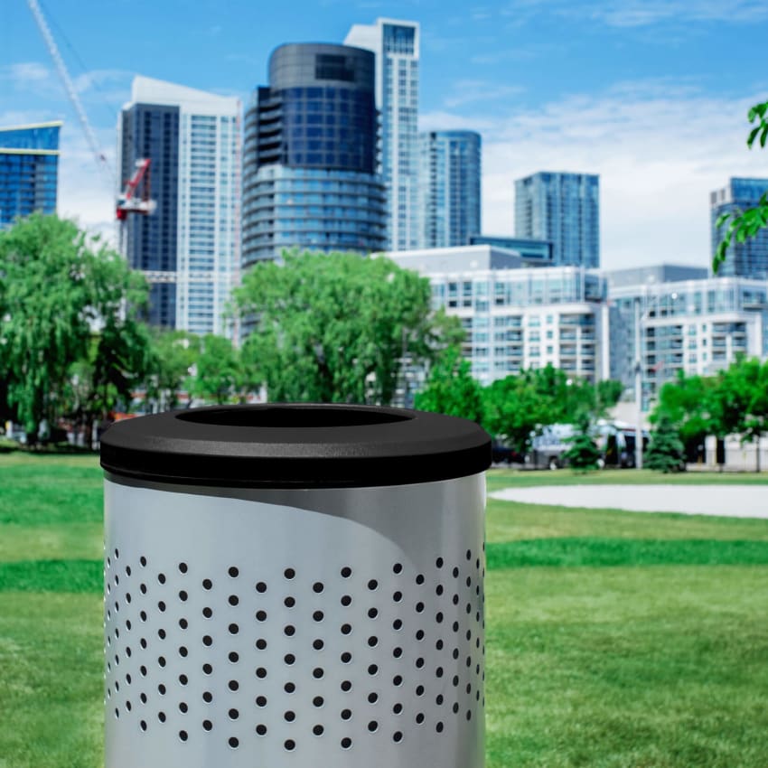 silver powder coated steel recycling bin with a blue liner and blue full opening lid outdoors on a busy city sidewalk with people walking by