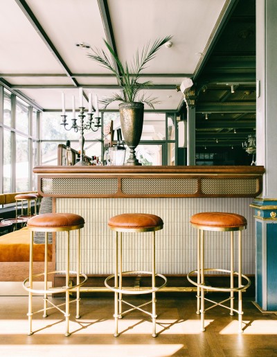 a bar with stools in front of it.