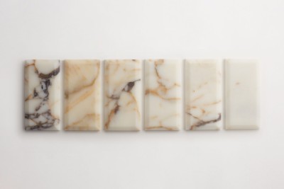 a set of marble tiles on a white surface.